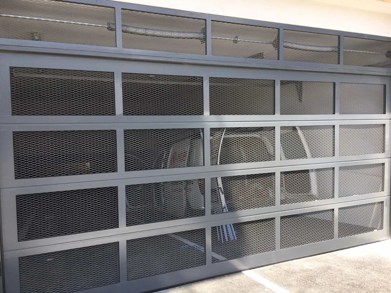Garage door with expanded-metal panels