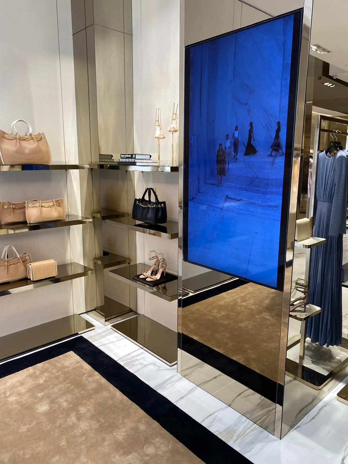 Shelves and a display screen in a boutique