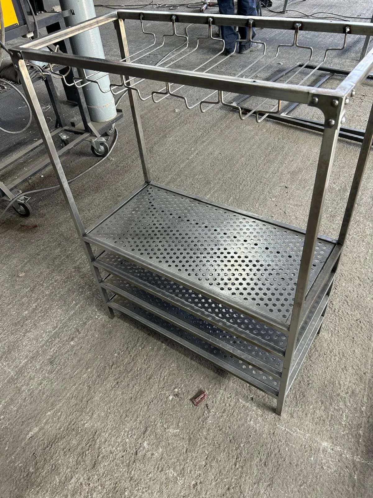 Rack with a perforated-sheet shelf